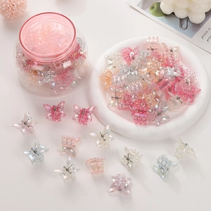 Colorful butterfly mini hair clips in a clear storage jar with pink screw lid