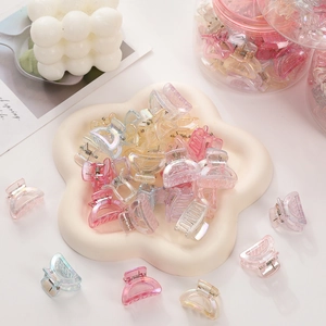 Mini macaron colored hair clips with iridescent finish in a decorative white floral tray