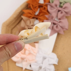 Detail of multi-color ribbed ribbon hair clips with secure fabric-wrapped metal duckbill clip