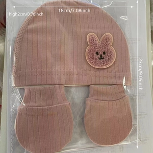 Ribbed organic cotton newborn hat and gloves set in pale pink with rabbit patch detail