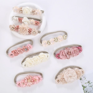 Detail of eight handmade floral baby headbands with pearls and rhinestone accents