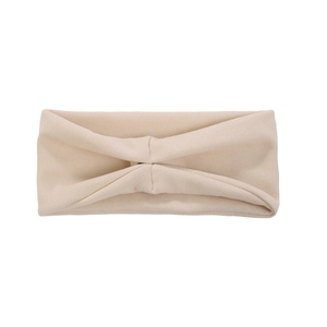 Detail of beige knotted headband featuring a soft knitted fabric and twisted design