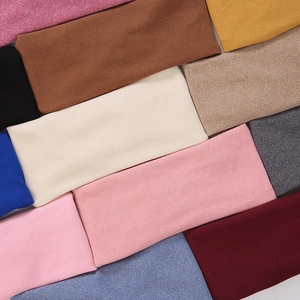 Detail view of multi-color elastic knitted headbands in assorted fabric textures