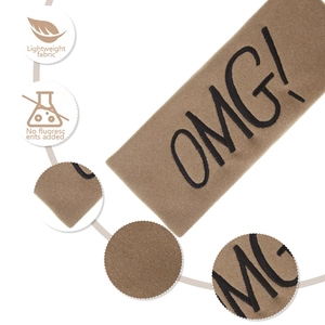 Detail showing the coffee plush fabric texture and OMG embroidery on the headband