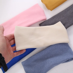 Close-up of assorted elastic spa headbands in various soft knit fabric colors