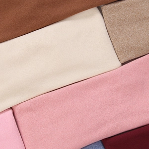 Detail showing various colors of soft faux cashmere elastic headbands with fine texture