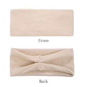 Detail showing the flat front and ruched back design of the elastic beige headband
