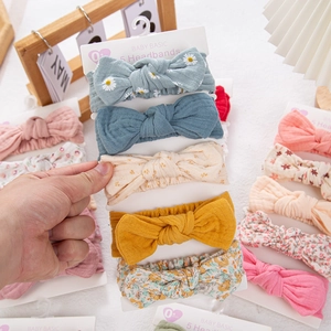 Detail of 5-piece floral baby headband set made of soft pleated cotton fabric