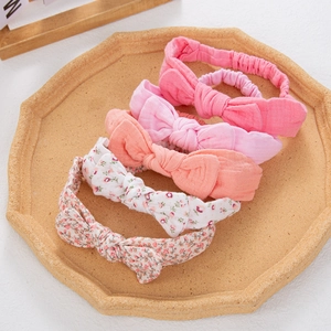 Detailed set of five floral and solid cotton baby headbands with elastic bands