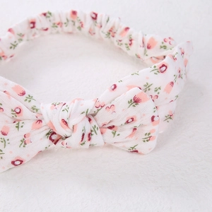 Detail of baby floral headband featuring elastic scrunchie back for comfortable fit