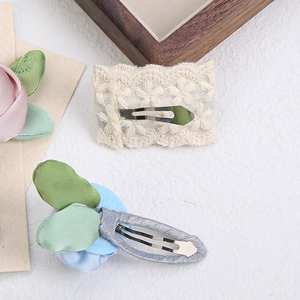 Lace flower embroidery and blue satin rose hair clips for girls on white background