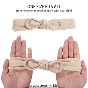 Close-up of beige cotton bow headband showing high elasticity and stretch to 52cm