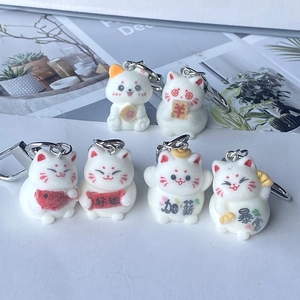 Set of six flocked Maneki Neko lucky cat keychains featuring various fortune symbols