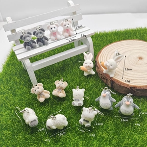 Detailed view of assorted flocked animal earrings including bears and bunnies on mini props