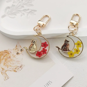 Cat in crescent moon keychain with real dried flowers in red and yellow resin charms