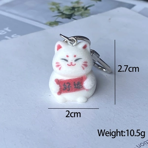 Detail of white flocked Maneki-Neko keychain with lucky scroll and size dimensions