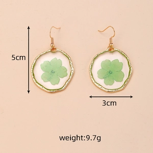 Detailed view showing dimensions and weight of gold earrings with green dried flowers