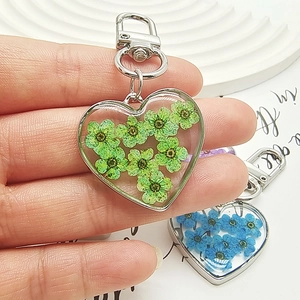 Handheld heart-shaped resin keychain with real dried flowers and silver lobster clasp