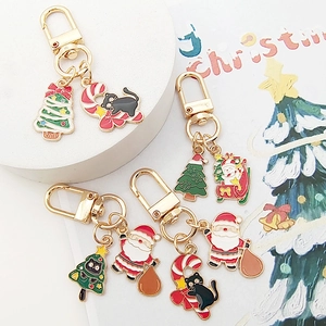 Cartoon Christmas keychain collection featuring Santa, cats and trees with gold clasps