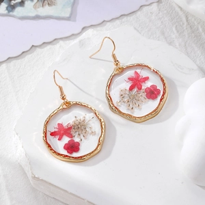 Handmade clear resin earrings with real dried flowers and gold circular metal frames