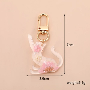 Detail view of cat resin keychain with real pink flowers showing 7x3.9cm dimensions