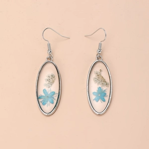 Boucles d'oreilles ovales en résine avec fleurs séchées bleues et blanches