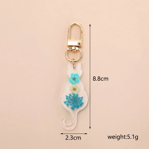 Detail view of resin cat keychain with real dried flowers and precise dimensions