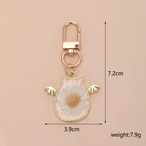 Detailed view of Halloween resin keychain with white daisy, gold foil, and dimensions 7.2x3.9cm