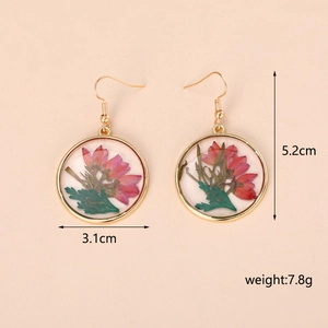 Handmade geometric resin earrings with pink dried flowers in gold circular metal frames