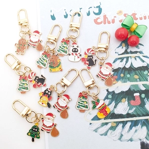 Christmas theme cartoon alloy keychain featuring Santa Claus and cute cat charms in gold finish