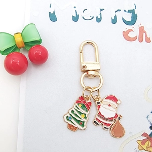 Christmas alloy keychain with enamel Santa Claus and festive tree charms in gold finish