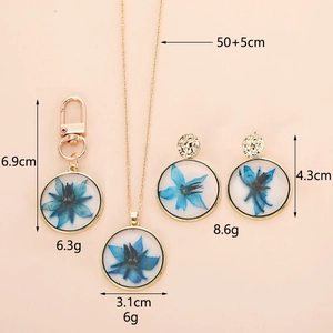 Blue dried flower resin jewelry set showing dimensions of necklace earrings and keychain