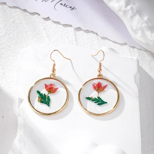Handmade gold resin drop earrings featuring real red dried flowers and gold foil accents