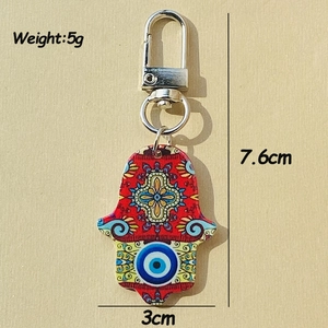 Detail of Hamsa Hand keychain with Evil Eye pattern and bohemian tribal design elements