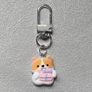 Cute cartoon Corgi puppy keychain with resin dog charm holding a pink gift box