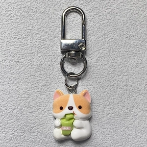 Close-up of cute Corgi keychain with green drink cup and durable silver metal clasp