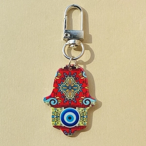 Detailed view of the red Hamsa Hand keychain with Evil Eye print and mandala patterns