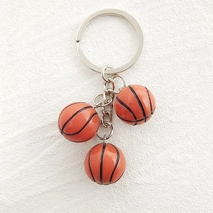 Detail view of mini basketball keychains with three resin ball charms on a metal ring