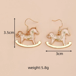 Detail view of rocking horse earrings with white dried flowers and 3.5cm size marks