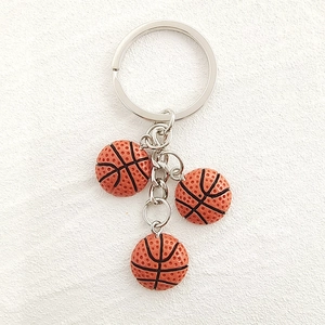 Detail of creative basketball keychain with three realistic resin mini balls and metal ring