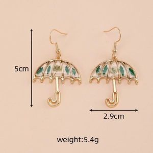 Detail view of umbrella-shaped gold earrings with green dried flowers and size specs