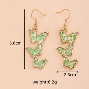 Detail view of butterfly earrings with green dried flowers showing 5.6cm height size