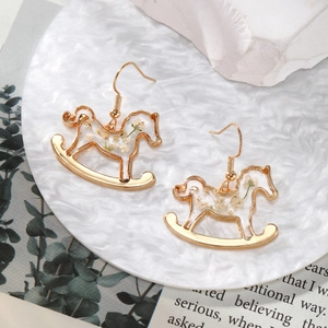 Handmade rocking horse earrings with real white dried flowers inside clear resin drops