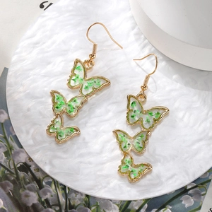 Handmade gold butterfly drop earrings with natural green dried flowers in clear resin