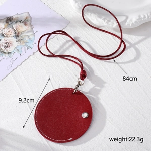 Detail of red leather sunglasses holder with silver snap button and braided neck strap