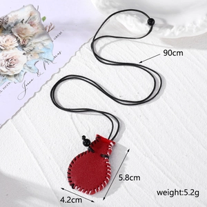 Detailed view of red leather necklace bag with dimensions 5.8x4.2cm and 90cm cord length