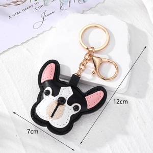 French Bulldog leather keychain with golden ring and lobster clasp on stone background