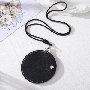 Minimalist round leather sunglasses holder with white stitching and silver snap button
