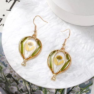Detailed hot air balloon drop earrings featuring yellow dried flowers in gold frames