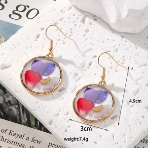 Detailed size view of round gold earrings with colorful dried flowers measuring 3cm by 4.9cm
